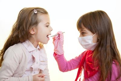 Two children playing dentist