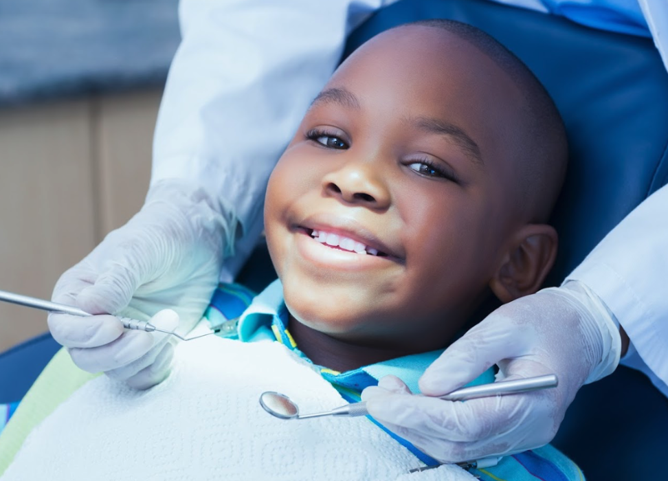 A smiling child at his first dental visit