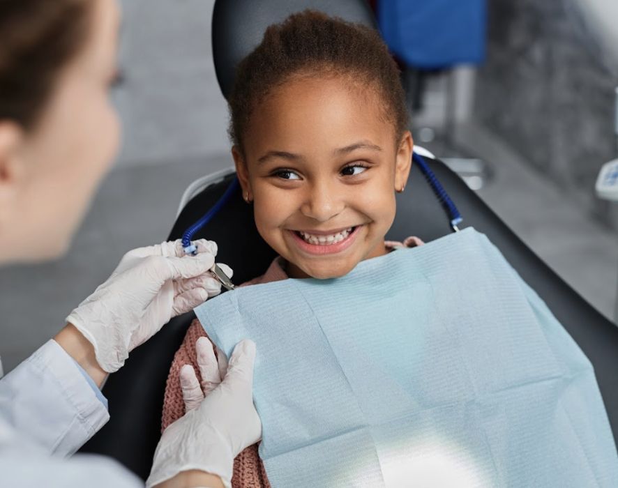A smiling girl in the dentist's chair