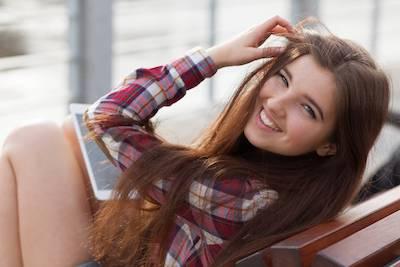 A smiling teen on her iPad