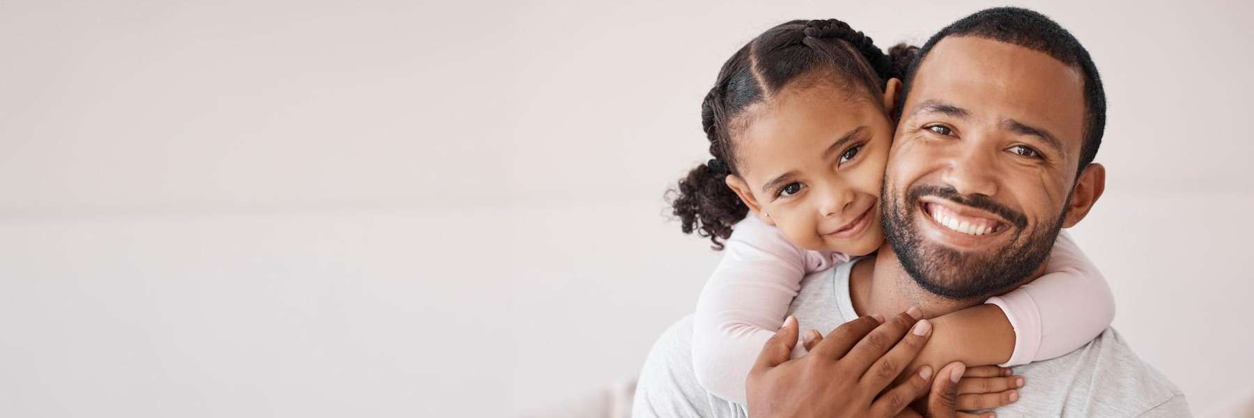 A smiling father and daughter