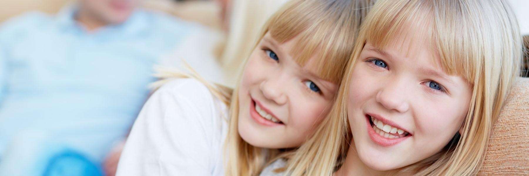 Smiling twin sisters | children's dentist Corona CA