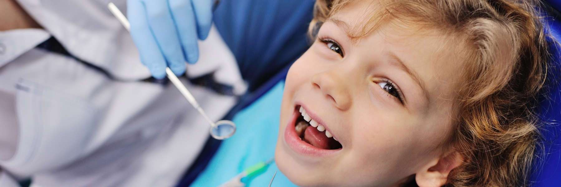A smiling boy getting a dental exam