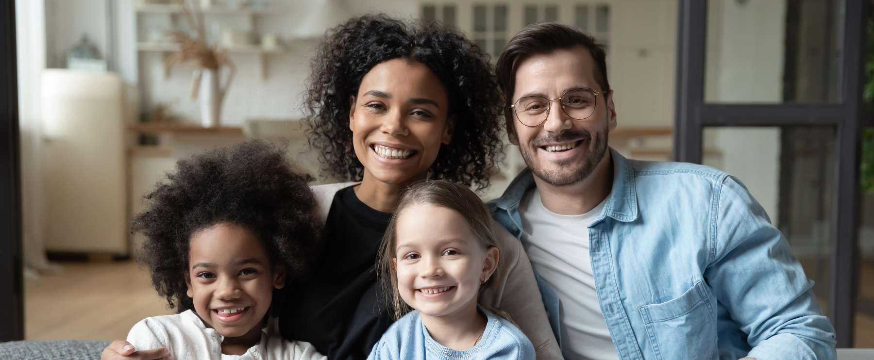 A smiling family in their home