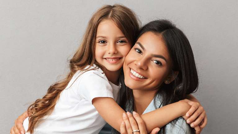 A smiling mother and daughter | children's dentist