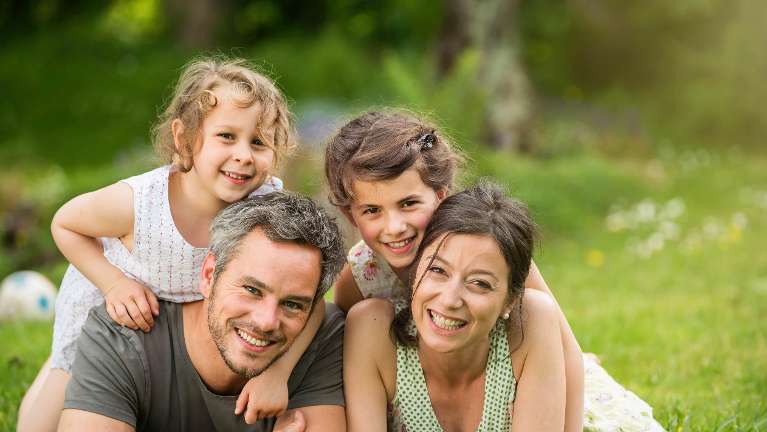 A happy family running in the woods