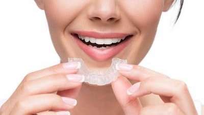 Woman smiling put in invisalign aligners, Corona CA