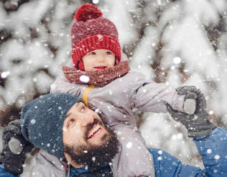 A father and son having fun in the snow