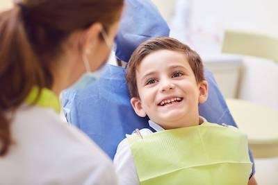 A happy child talking to his pediatric dentist