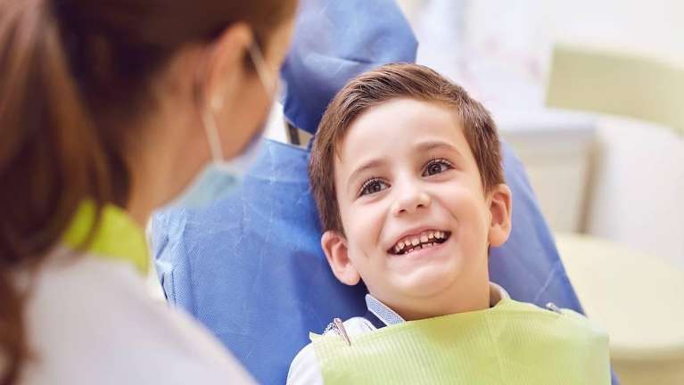 A little boy smiling at his dentist